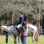 Coral coaching a student at a horse show.